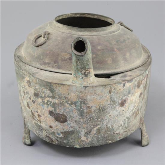 A Chinese archaic bronze steamer vessel, in two parts, Xian, Han dynasty, 206 B.C.-220 A.D., 30cm long, holes